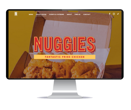 Desktop monitor displaying the NUGGIES (fried chicken shop) website, which Social Space designed.