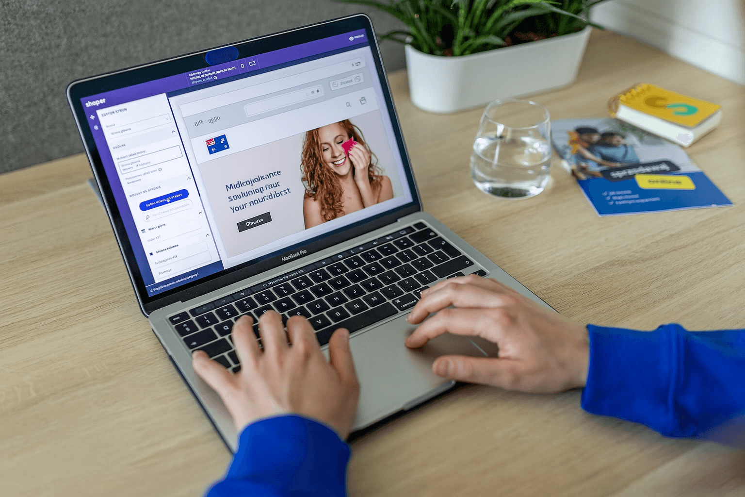 A person is typing on a laptop with ecommerce store of a woman on the screen