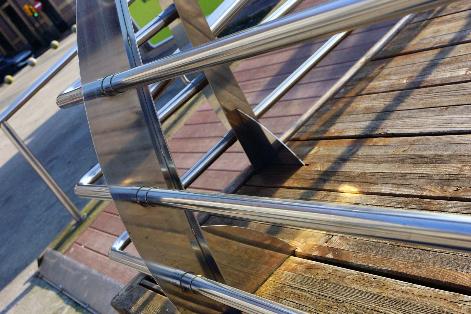 A close up of a metal railing on a wooden deck