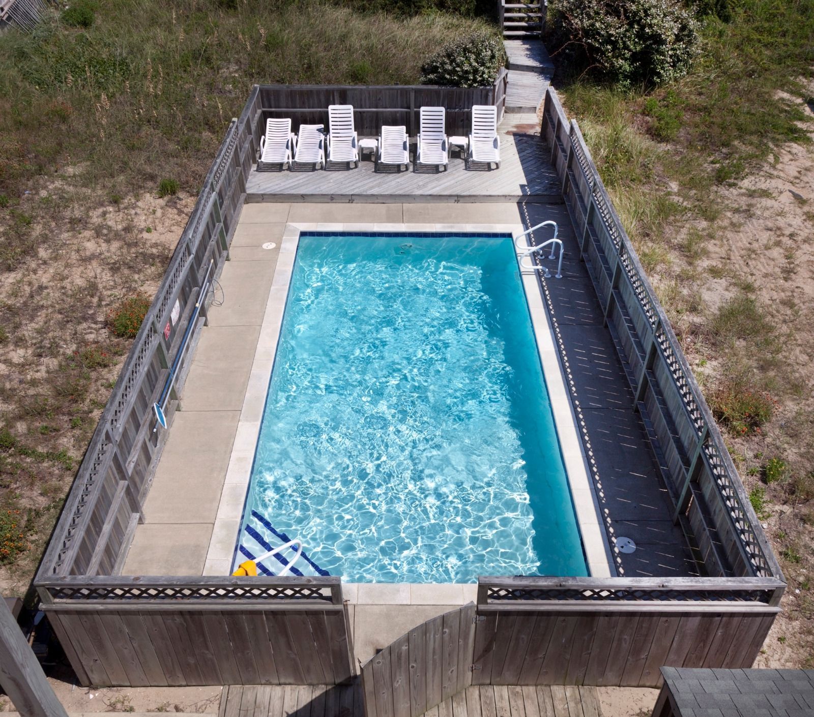 An aerial view of a large swimming pool surrounded by chairs
