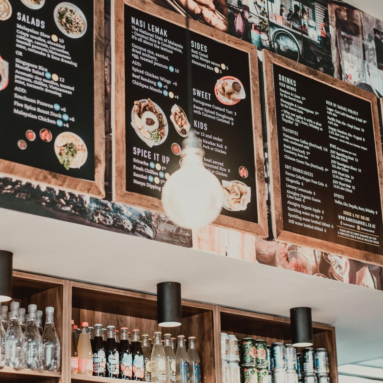 A restaurant with a menu hanging from the ceiling