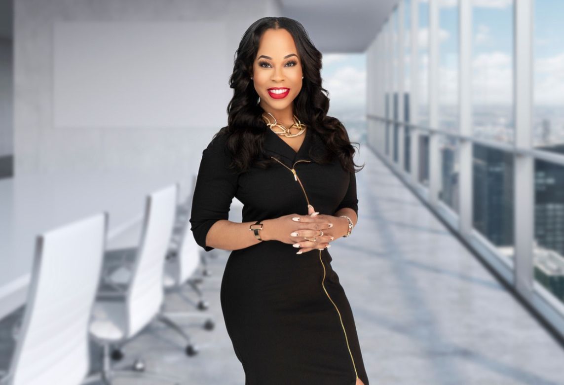 A woman in a black dress is standing in a conference room.