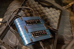 Blue Cardag-M device in an open case, connected to a cable, likely for medical monitoring.