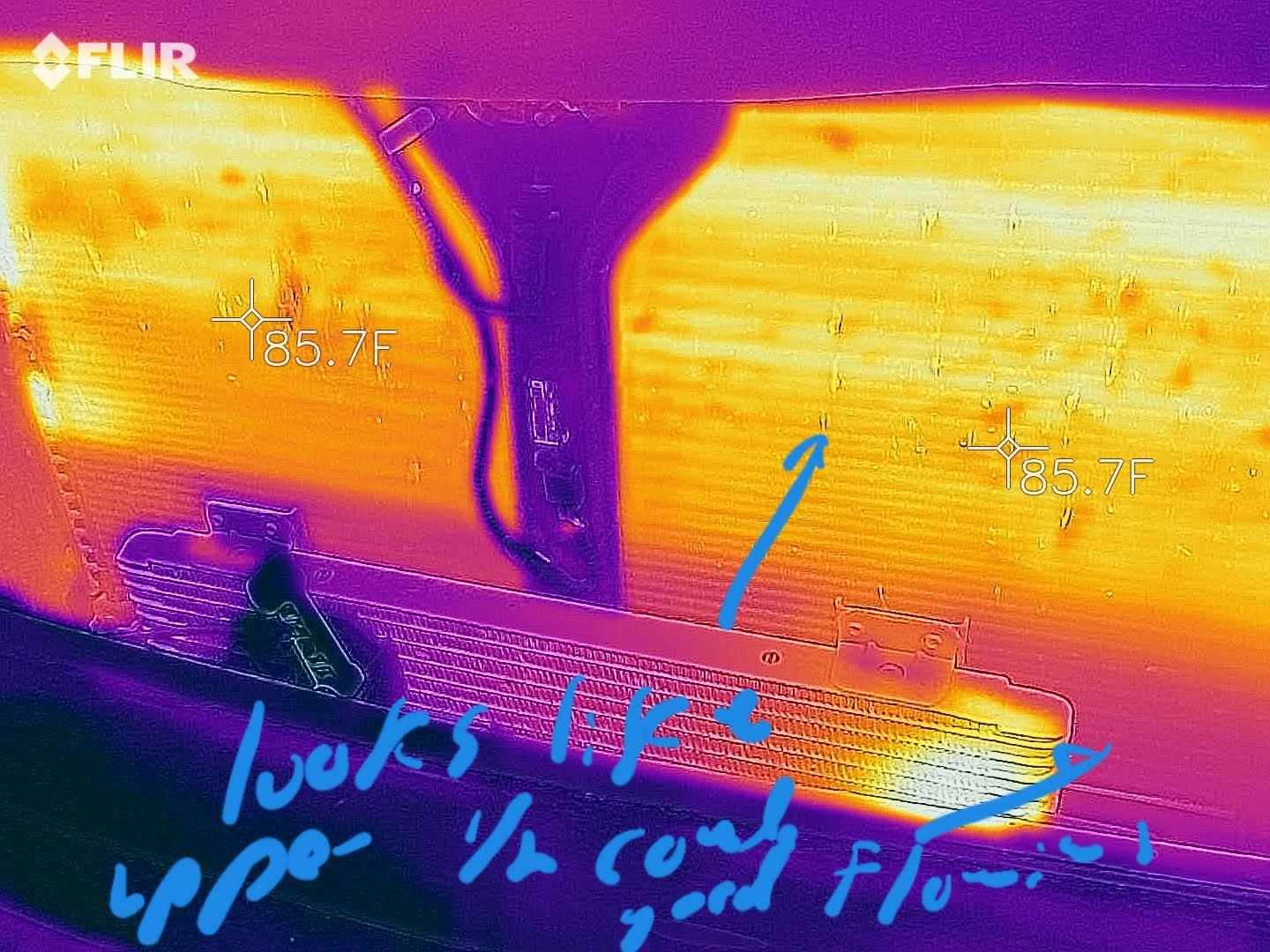 Thermal image shows a yellow/purple view of a structure. Text notes a cooler upper half and a warm lower section. | Accomplished Automotive