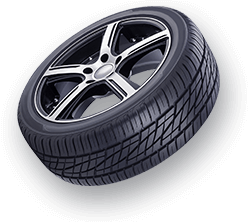 Car tire with silver and black rim, angled perspective.