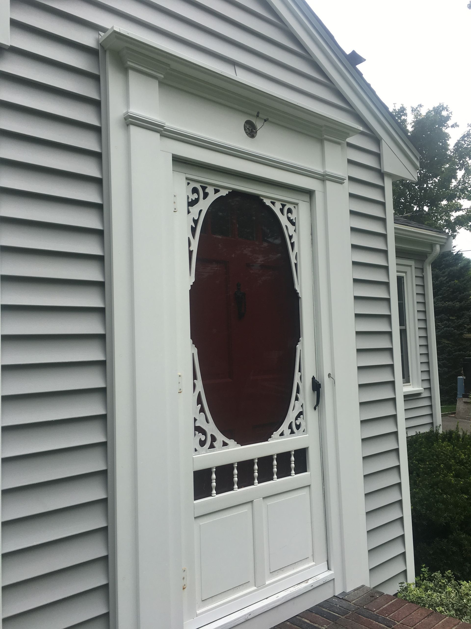 A white house with a red door and a window