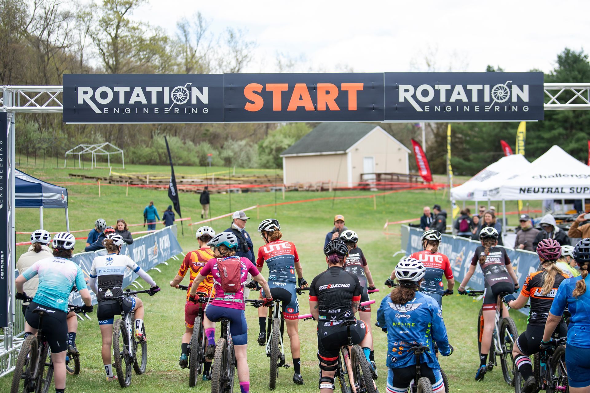 Mountain bikers at the starting line, under a