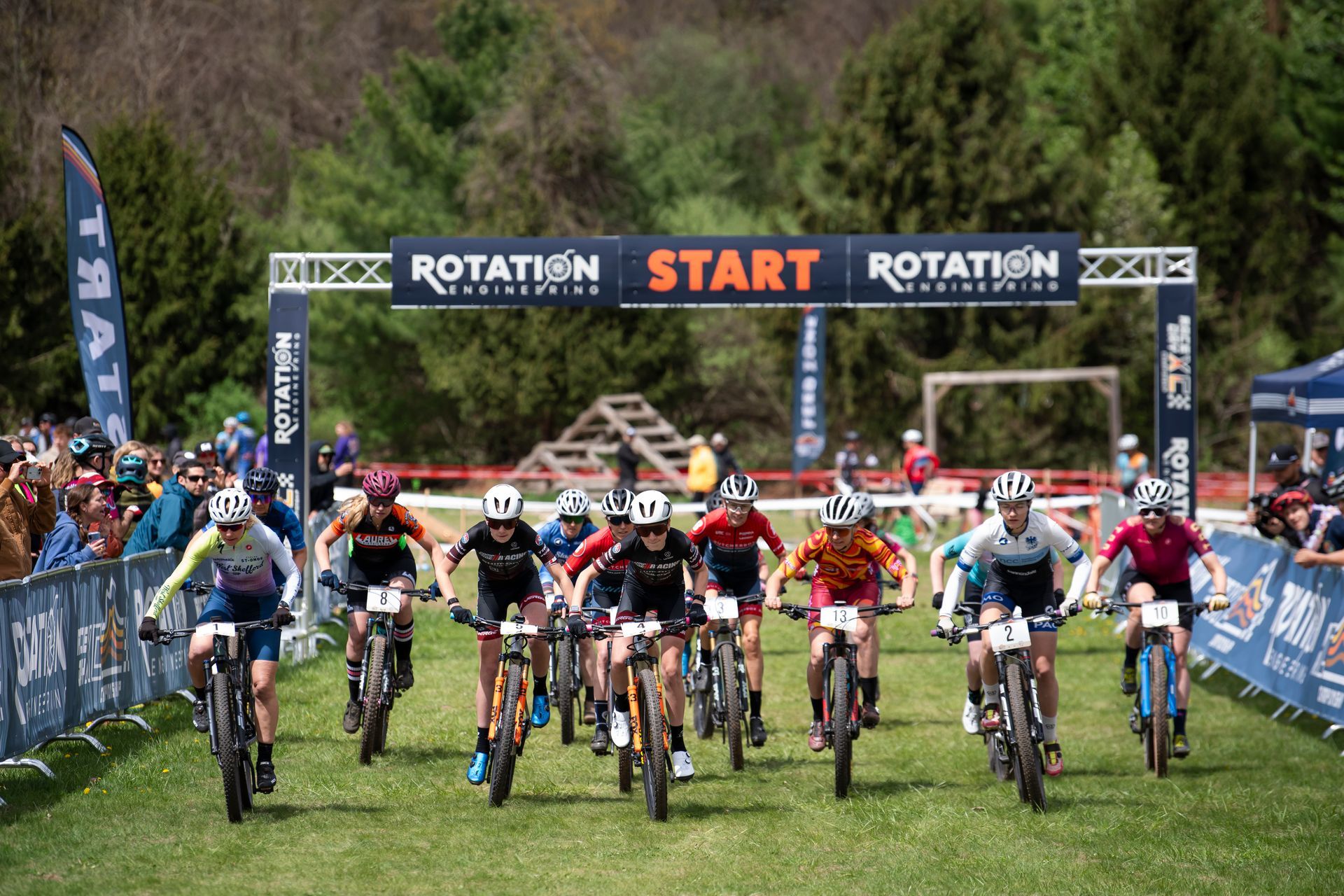 Mountain bikers at the starting line of a race, under an