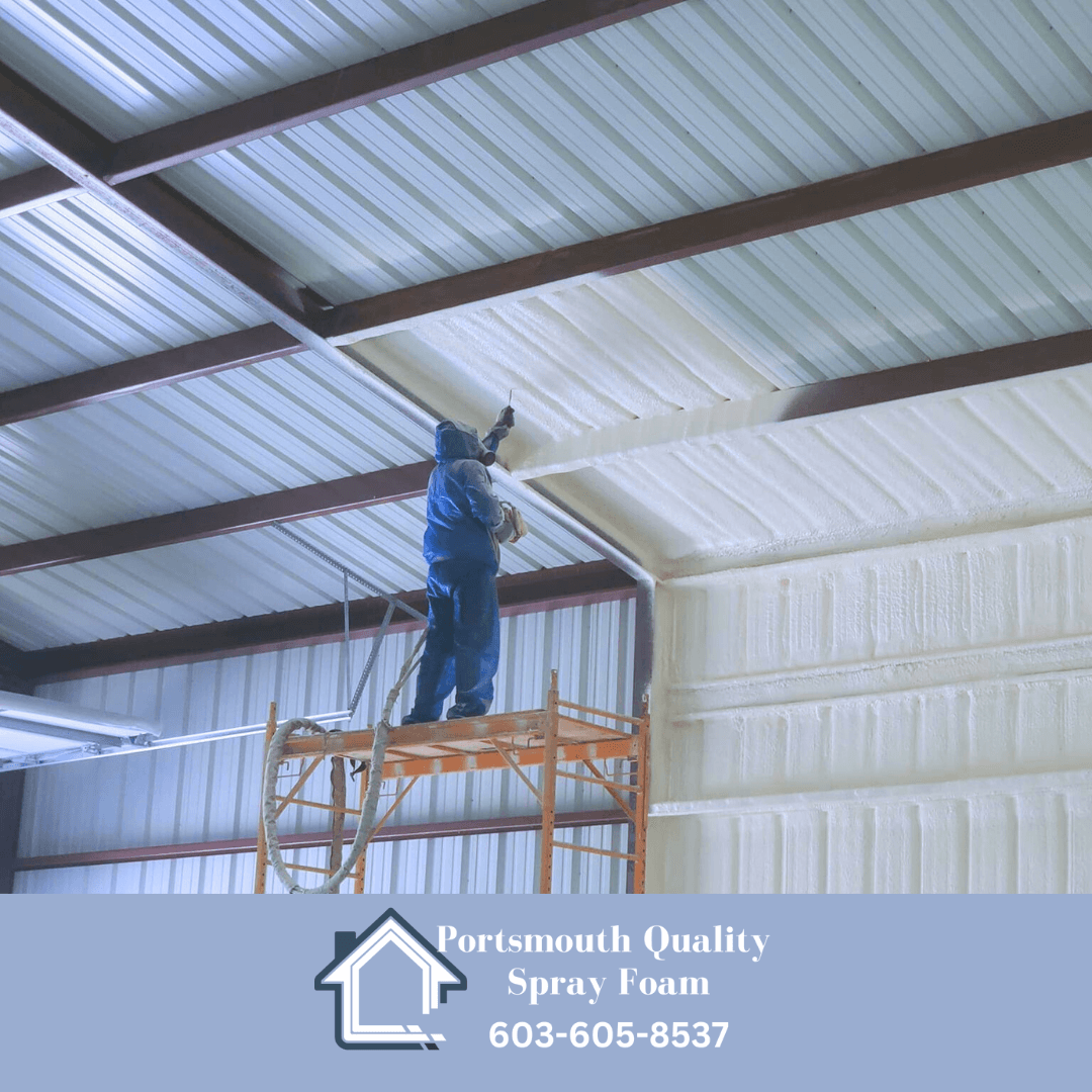 Man on staging installing spray foam in a commercial metal building