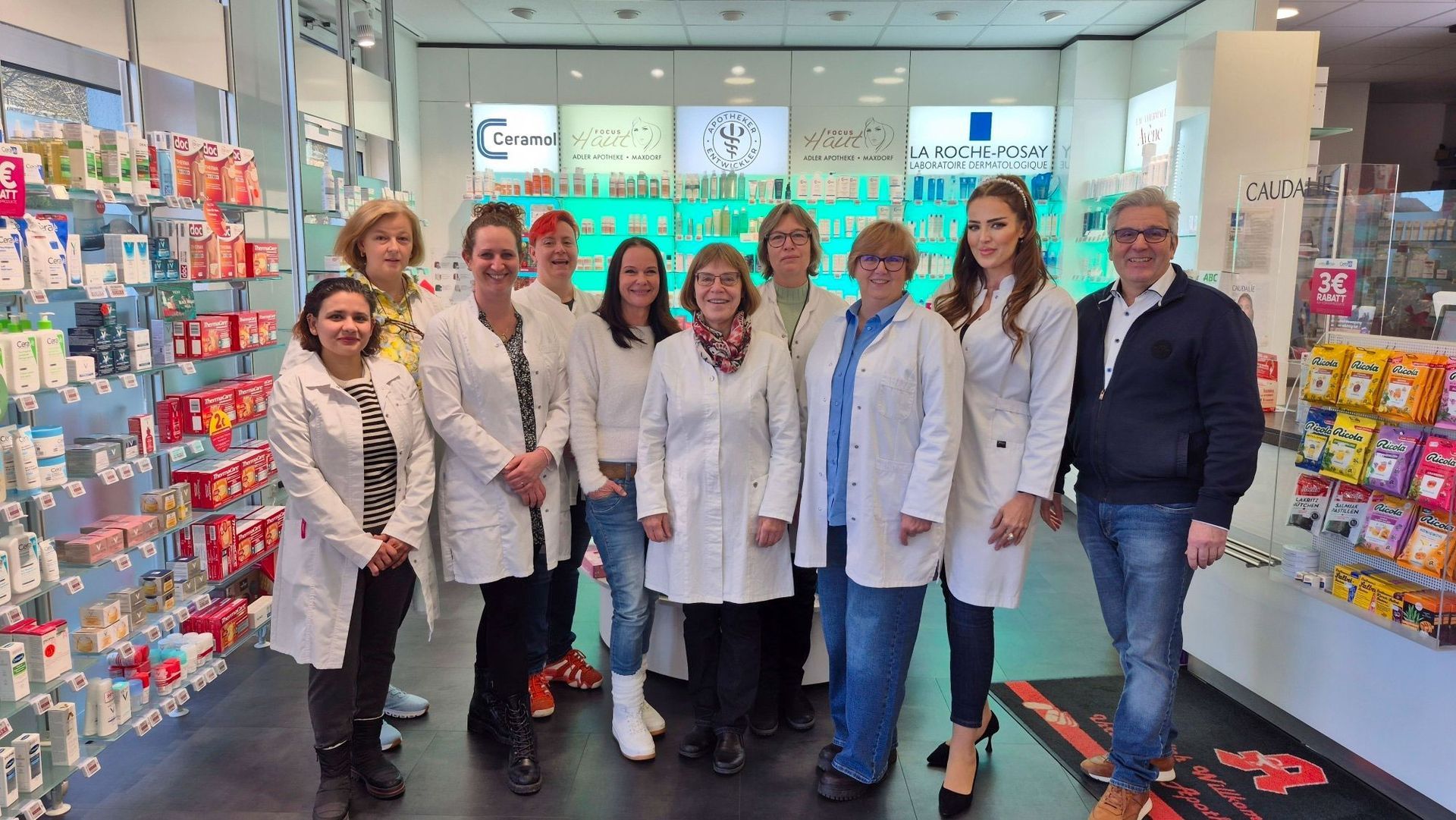 Eine Gruppe von Menschen posiert vor einem Gebäude für ein Foto.