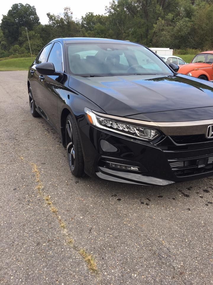Black Honda Accord parked on asphalt, front view.