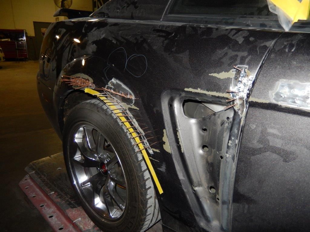 Car rear quarter panel damage and repair work in progress.