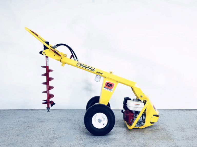 A yellow tractor with a drill attached to it