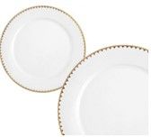 Two white plates with a gold rim on a white background.