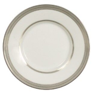 A white plate with a silver rim on a white background