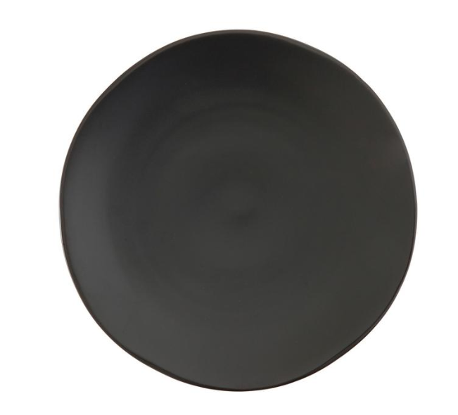 A black plate is sitting on a white surface.