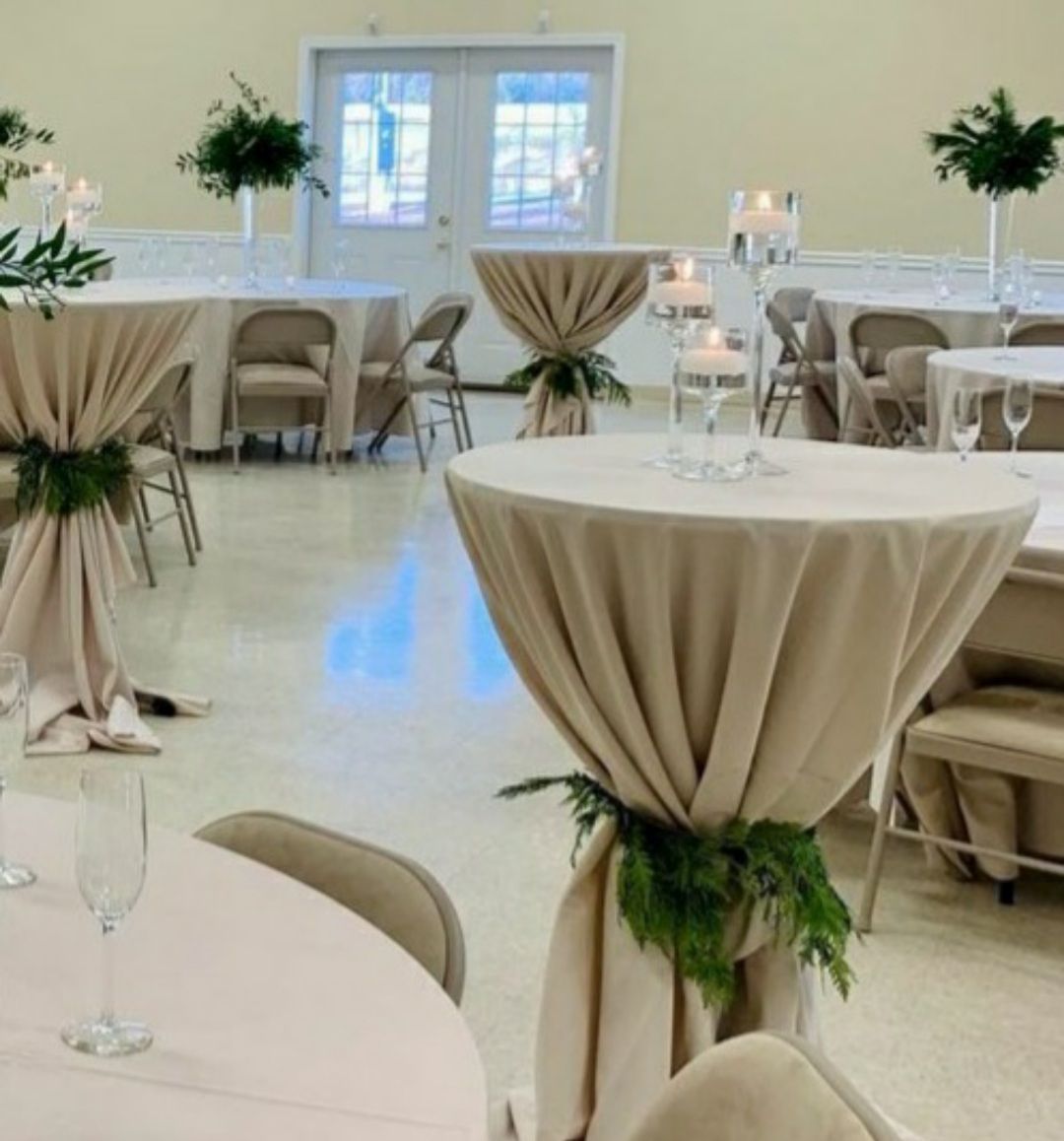 A room with tables and chairs and candles on them