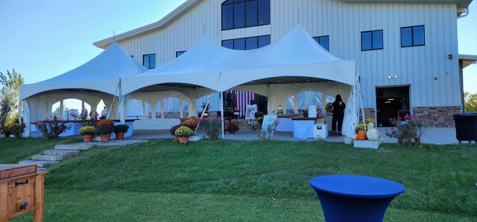 A white tent with tables and chairs underneath it