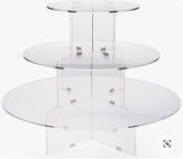 A clear acrylic cupcake stand with three tiers on a white background.