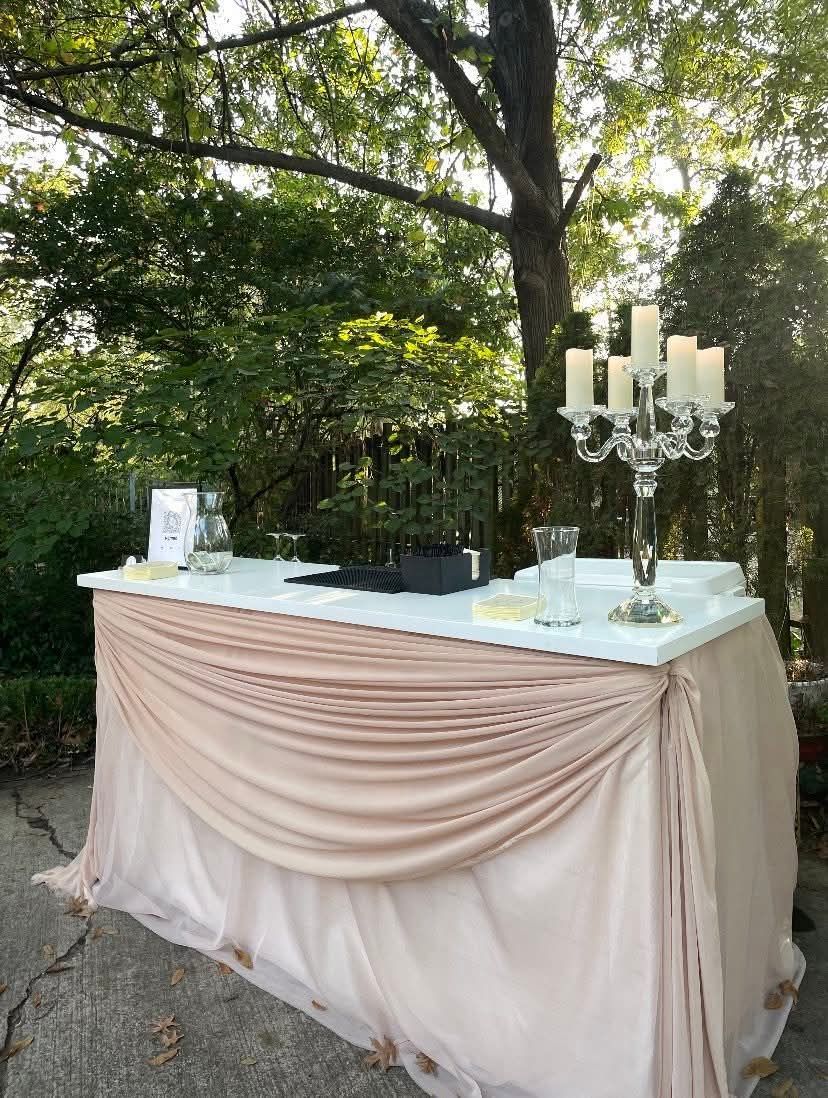 A table with a table cloth and candles on it.