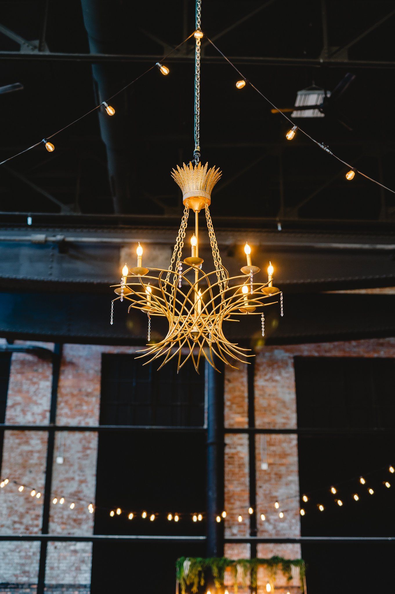 A chandelier is hanging from the ceiling in a dark room.
