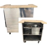 A stainless steel bar with a wooden top and wheels.