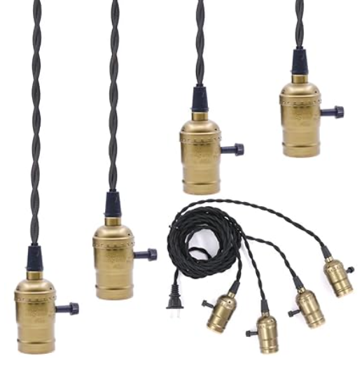 A set of brass light bulb holders with black wires
