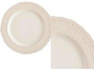 A white plate with a lace rim on a white background.