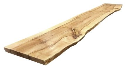 A long piece of wood is sitting on a white surface.