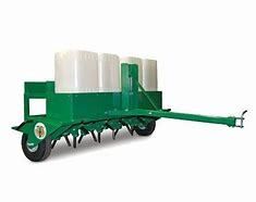 A green and white trailer with a tractor attached to it.