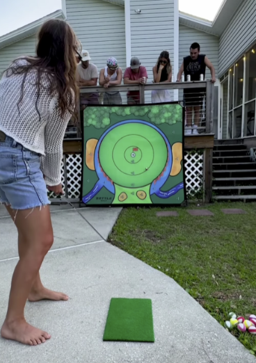 A woman is standing in front of a painting of a target