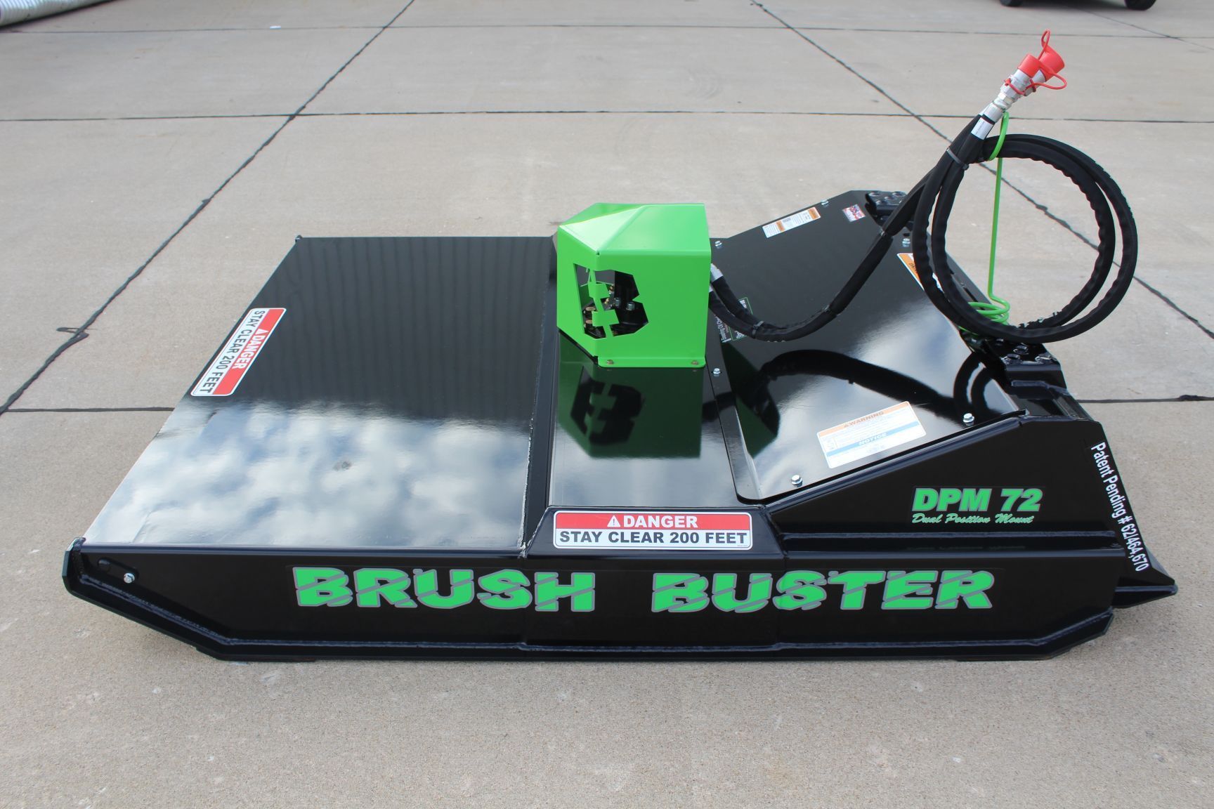 A brush buster sits on a concrete surface