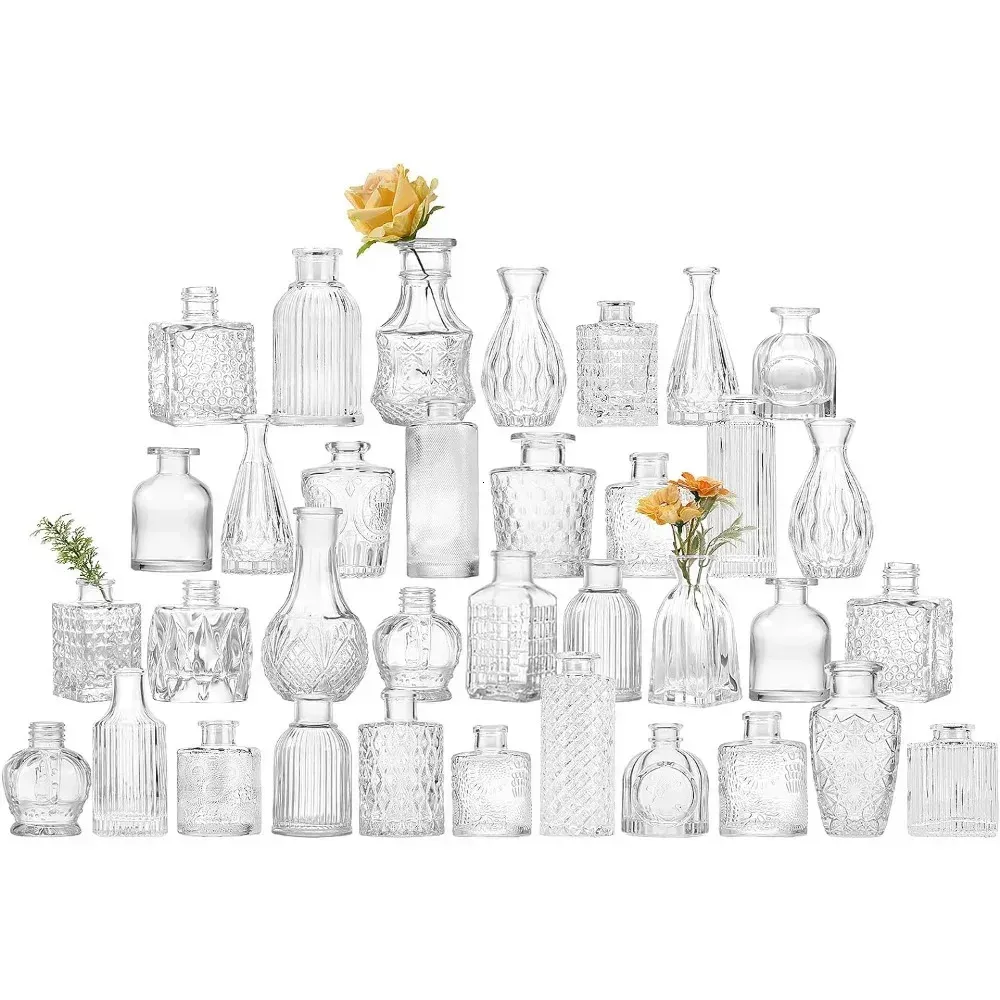 There are many different types of glass vases with flowers in them.