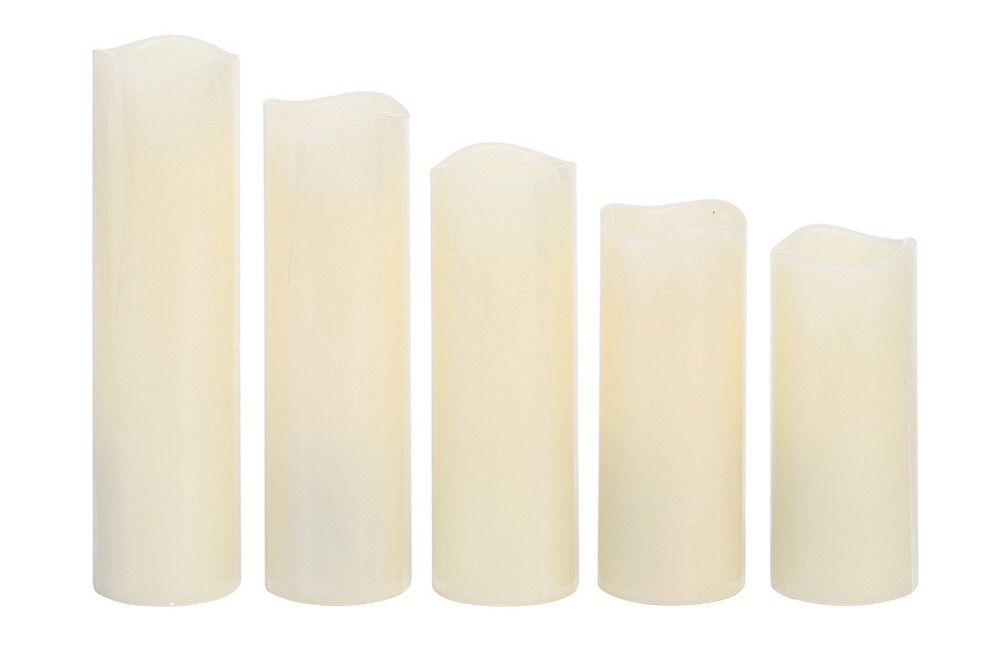 A row of white candles of different sizes on a white background.