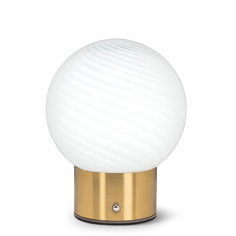 A table lamp with a white glass globe and a brass base.