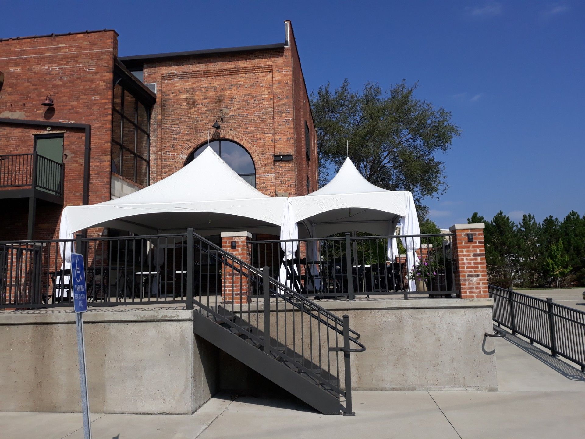 A brick building with two white tents in front of it