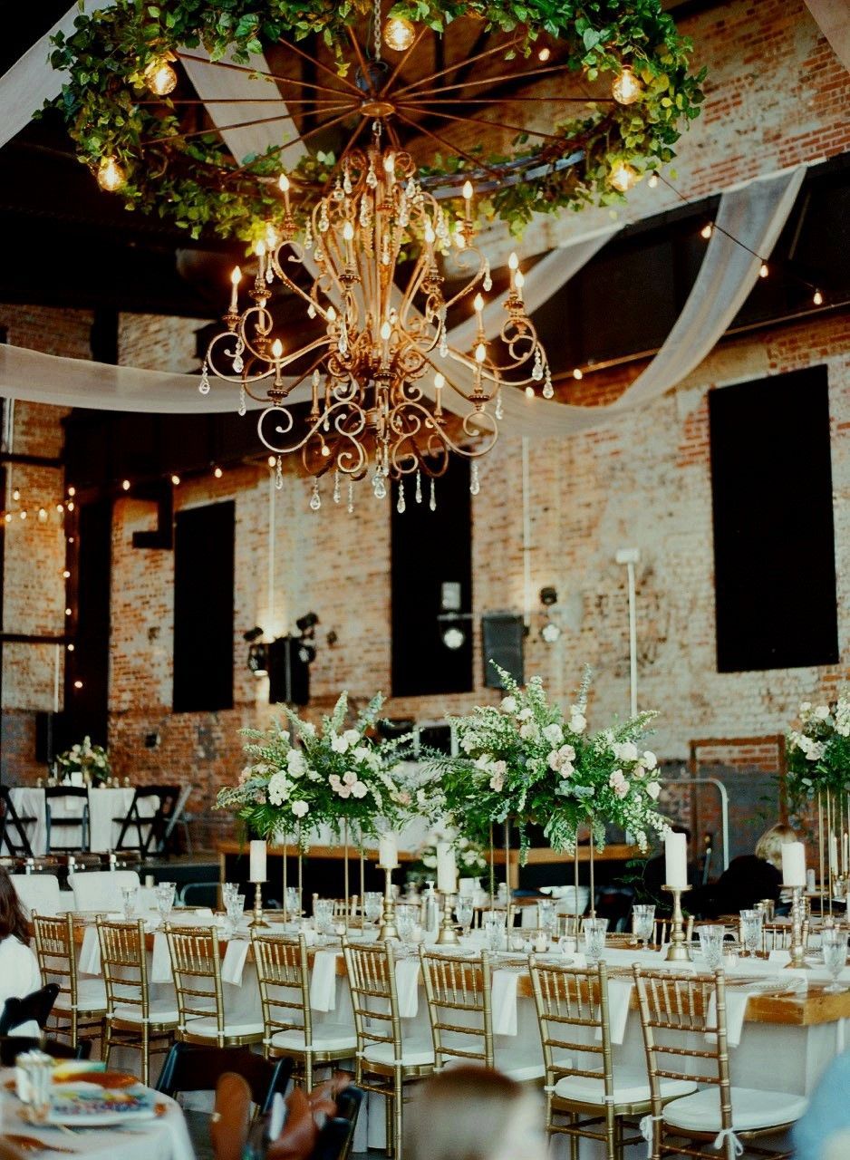 A large room with tables and chairs and a chandelier