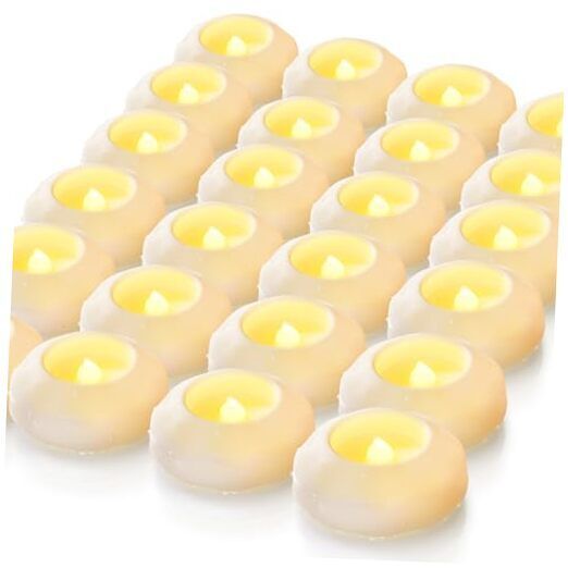A bunch of candles are sitting on top of each other on a table.