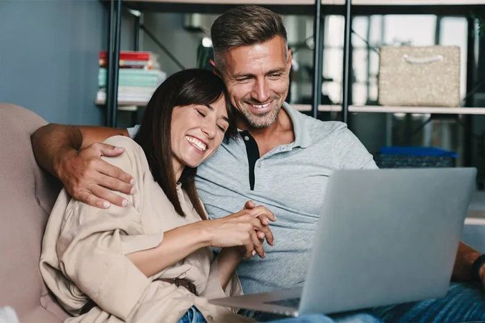 image of couple searching on laptop