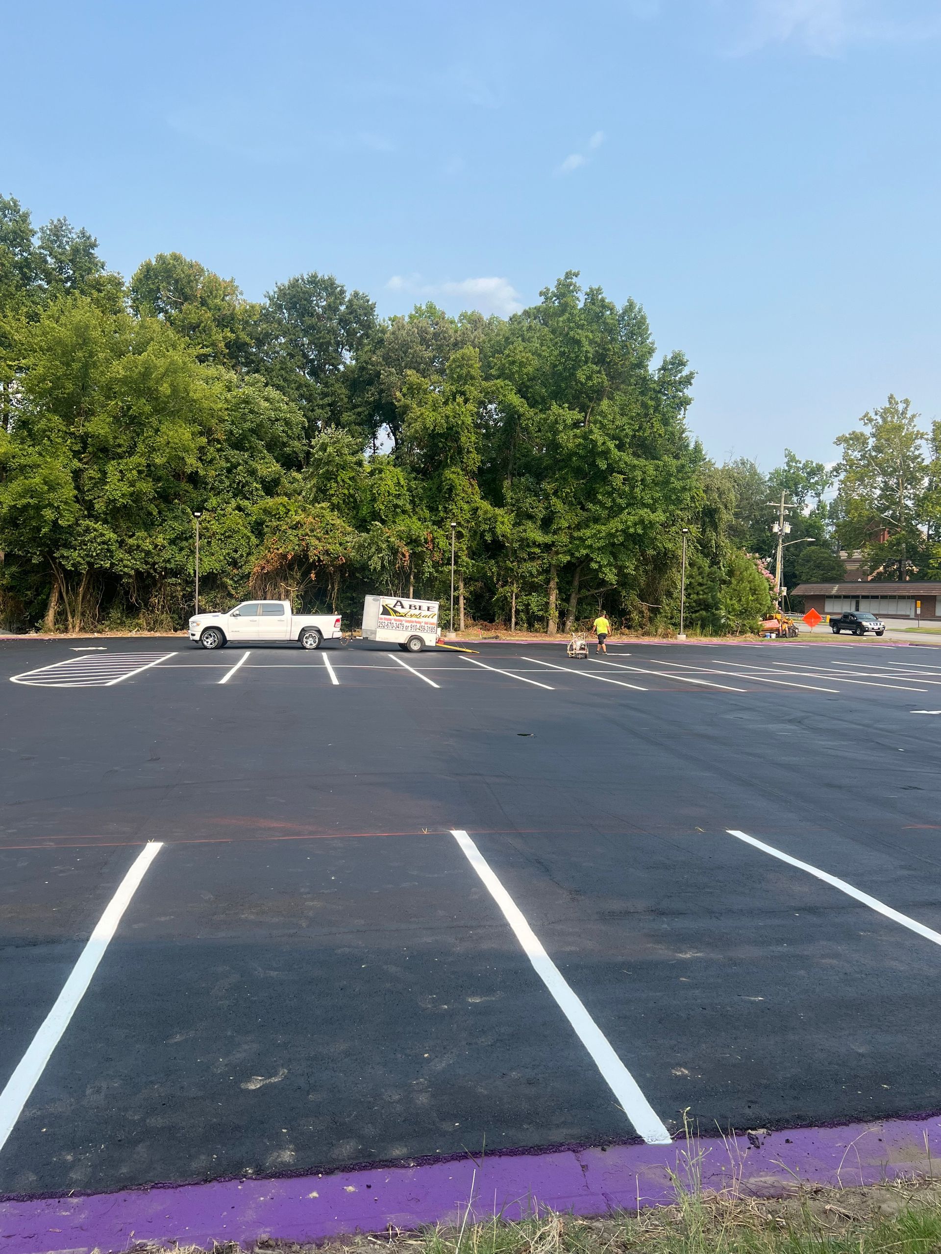 A parking lot with a white truck parked in it