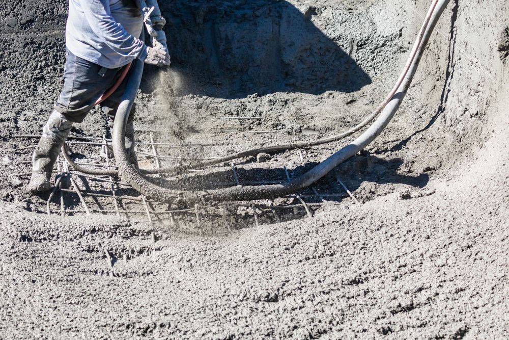 Construction Worker Spraying Concrete Onto Rebar in a Curved Space — Nambucca Concrete Pumping in Port Macquarie, NSW