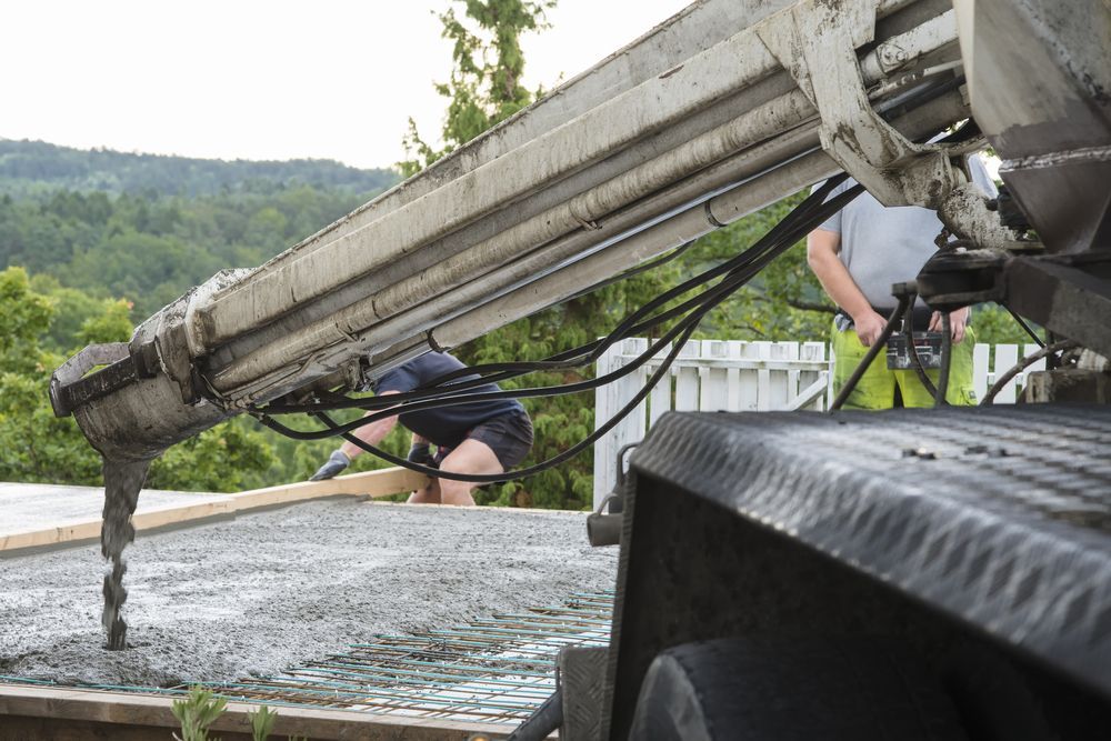 Concrete Being Poured Onto a Deck From A Truck-mounted Boom — Nambucca Concrete Pumping in Kempsey, NSW
