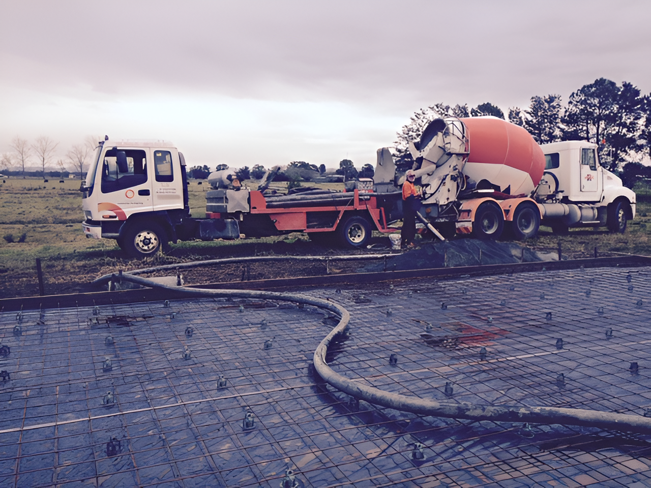 Concrete Pour on Rebar Grid, Concrete Trucks, Orange Pump Truck, Outdoor Setting — Nambucca Concrete Pumping in Valla, NSW