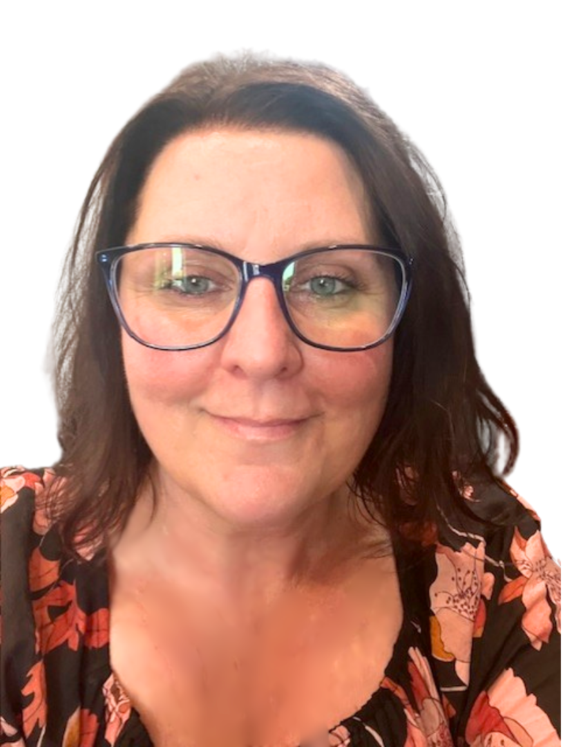 Woman with short brown hair smiles, leaning against a gray brick wall, wearing a blue turtleneck.