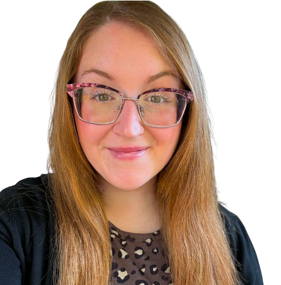 Woman with brown hair smiles, wearing black turtleneck and black/white striped cardigan.