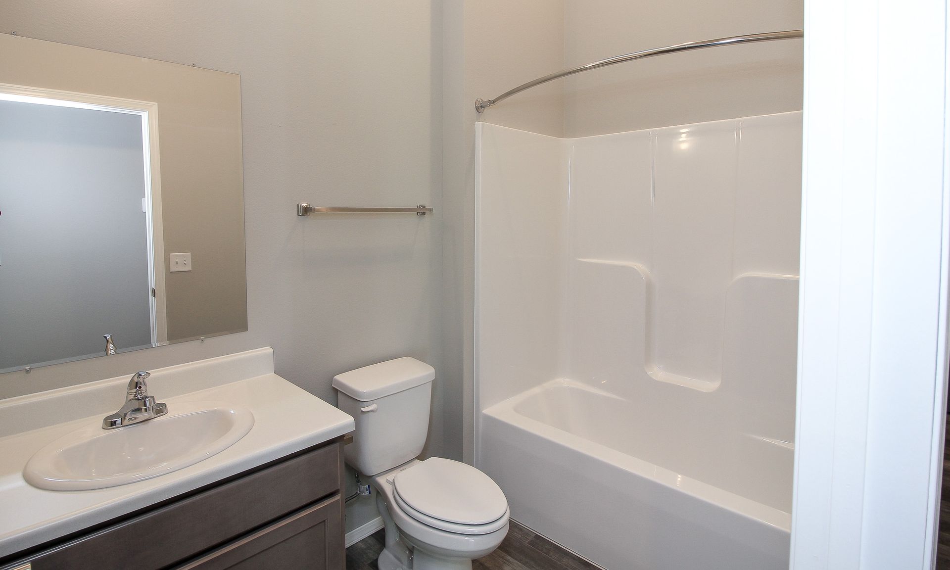 Stacked washer and dryer in a closet alcove with a partially open door