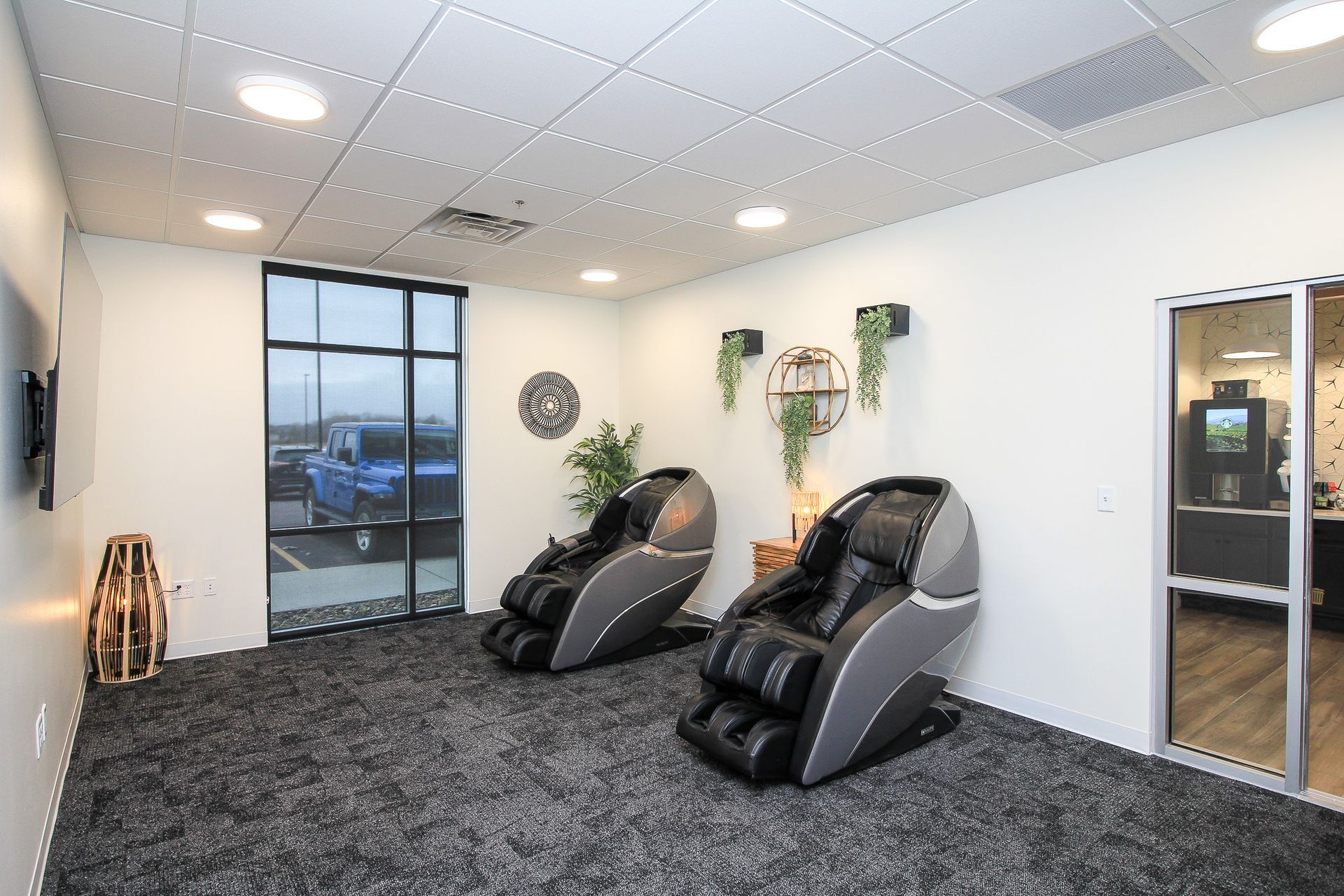 Gym with treadmills, elliptical machines, and weights on a red carpeted floor