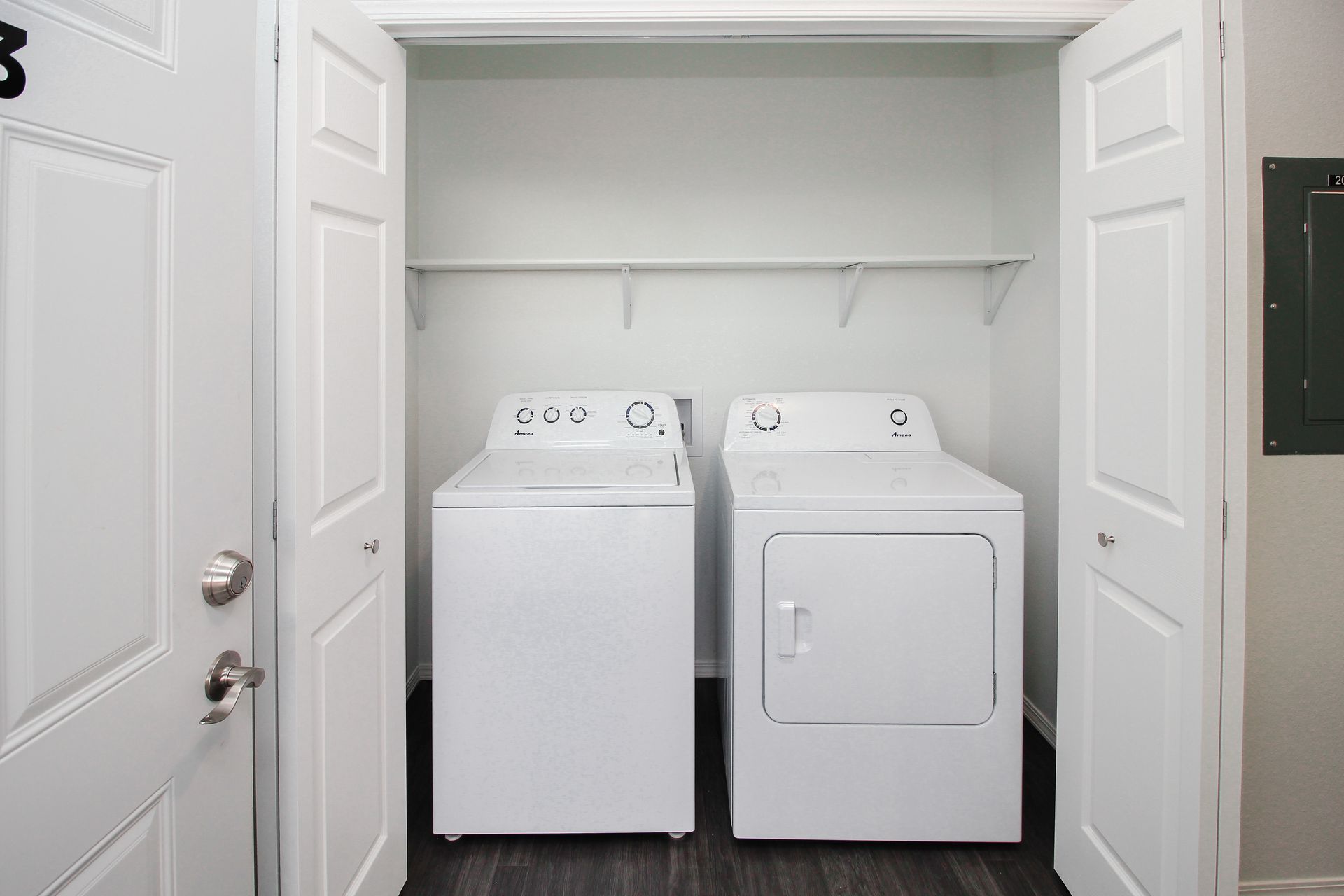 White washer and dryer in a closet with open doors