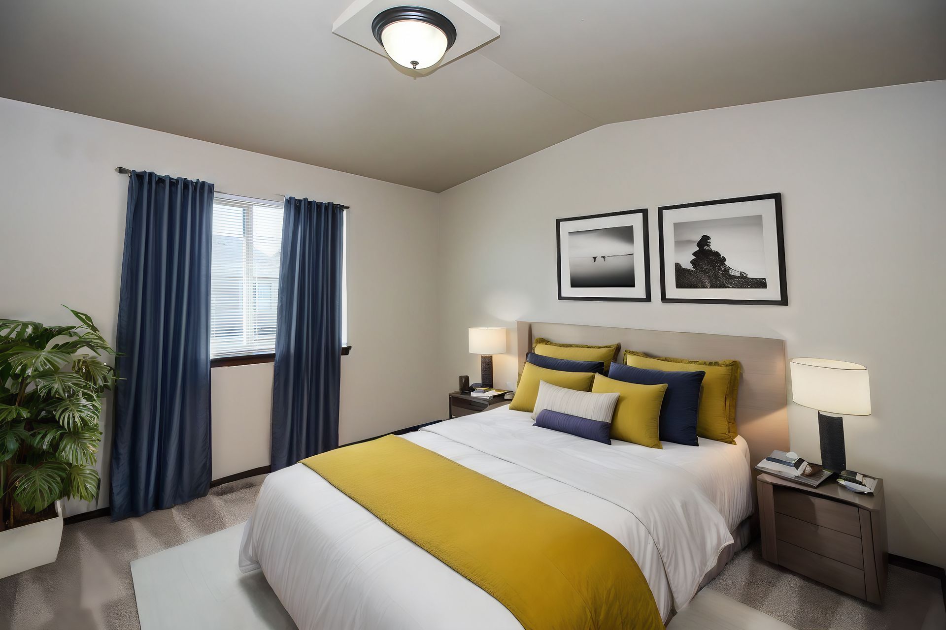 Bright bedroom with a bed, yellow accents, blue curtains, and framed wall art