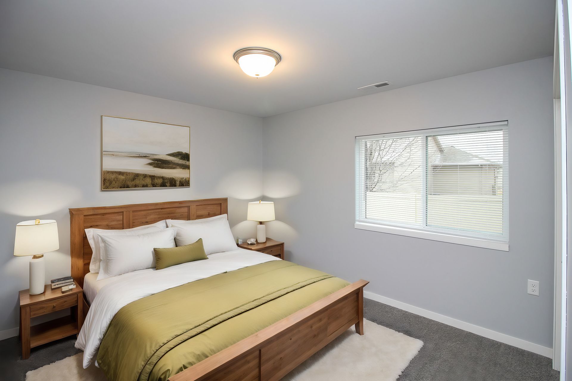 Bright bedroom with wooden bed, white bedding, bedside lamps, and a window with blinds